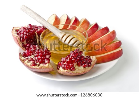 Cut into slices of apples, pomegranate and bowl of honey over white. Illustration of Rosh Hashanah (jewish new year) or Savior of the Apple Feast Day