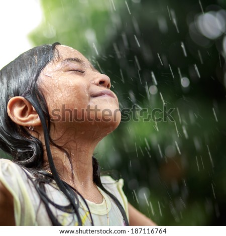 Closeup little girl in the summer rain