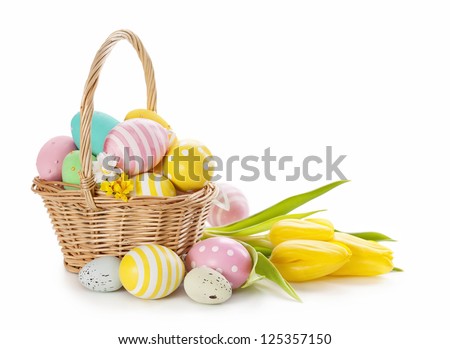 Basket with easter eggs on white background - stock photo