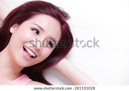 portrait of a Happy young beautiful woman relax lying and look to empty area in the image, great for your design, asian beauty