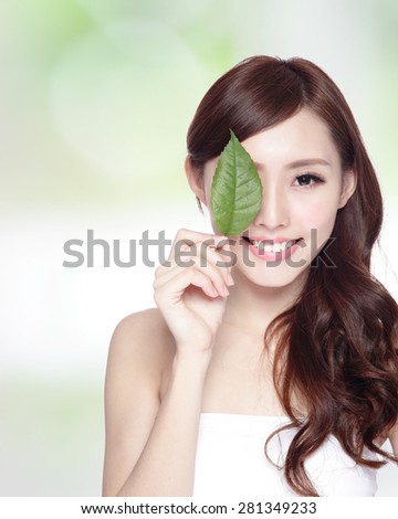 beautiful woman face portrait with green leaf , concept for skin care or organic cosmetics , asian beauty