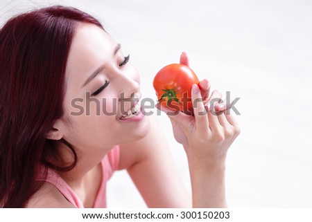 Health girl show tomato with smile face, health food concept, asian woman beauty