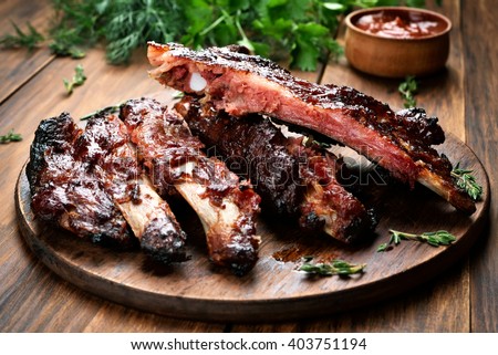 Roasted sliced barbecue pork ribs, focus on sliced meat