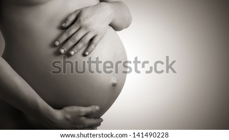 belly of pregnant woman monochrome on a dark background