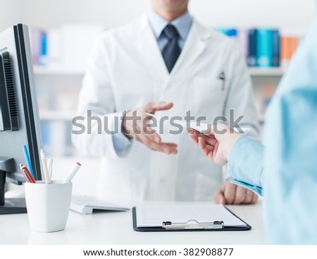 Customer giving a medical prescription to the pharmacist, treatment and healthcare concept