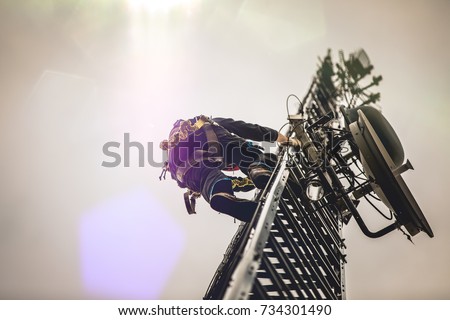 Telecom Worker Climbing Antenna Tower