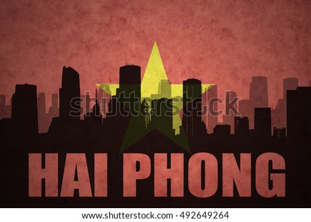 abstract silhouette of the city with text Hai Phong at the vintage vietnamese flag background