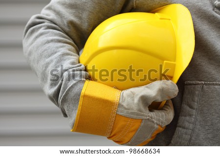 Man holding yellow helmet close up