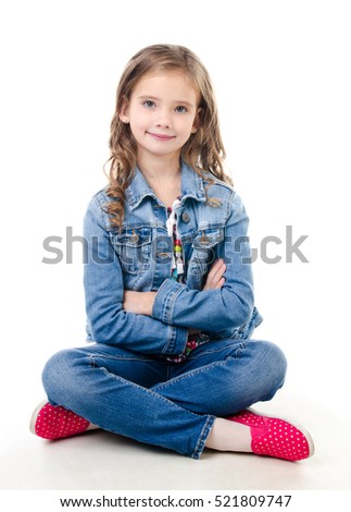 Adorable smiling little girl sitting on a floor isolated on a white