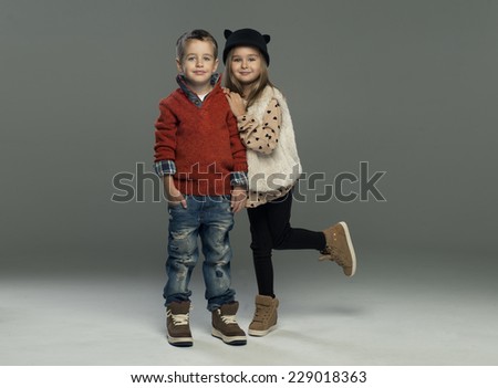A portrait of a laughing girl and a smiling boy. Autumn style