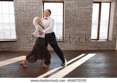 http://thumb1.shutterstock.com/display_pic_with_logo/90989/606870590/stock-photo-full-of-harmony-graceful-talented-flexible-elderly-couple-dancing-in-the-ballroom-while-improving-606870590.jpg