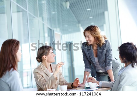 Image of four businesswomen interacting at meeting