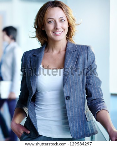 Image of pretty businesswoman looking at camera