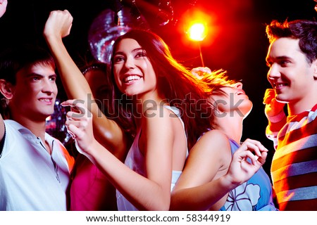 Photo of energetic girl dancing in the night club with her friends on ...