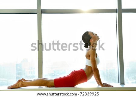 Portrait of young sporty girl doing stretching exercise