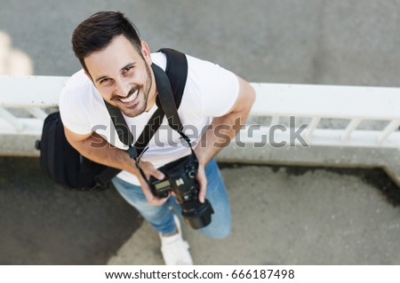 Portrait of male photographer with camera
