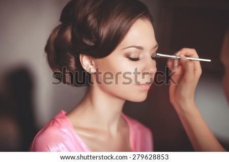 Beautiful young bride with wedding makeup and hairstyle in bedroom, newlywed woman final preparation for wedding. Happy Bride waiting groom. Marriage Wedding day moment. Bride portrait soft focus