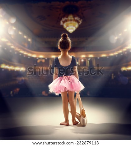 little girl plays in the ballet