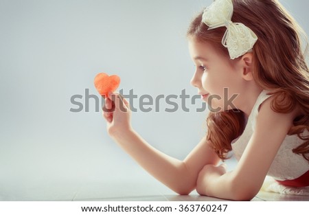 Happy Valentine's Day! Sweet child girl with red heart. Wedding and Valentine concept.