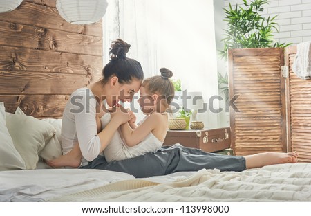 Happy loving family. Mother and her daughter child girl playing and hugging.