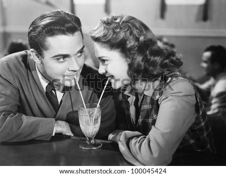https://thumb1.shutterstock.com/display_pic_with_logo/921176/100045424/stock-photo-couple-in-a-restaurant-looking-at-each-other-and-sharing-a-milk-shake-with-two-straws-100045424.jpg