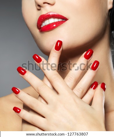Young woman with fashion red nails and sensual lips - Model posing in studio