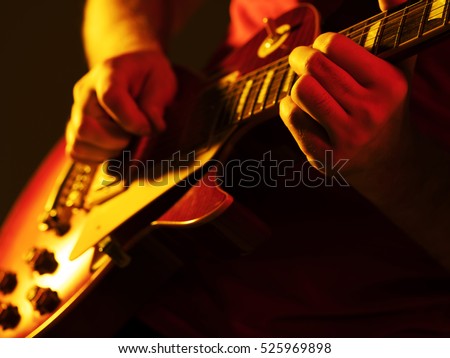 man playing guitar on a stage musical concert close-up view