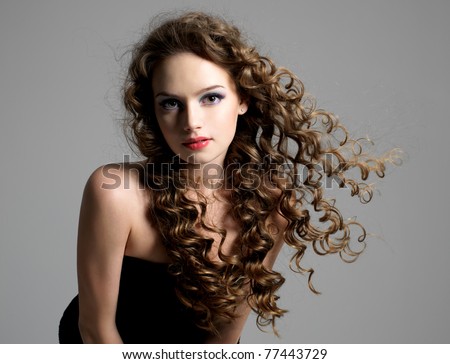 Portrait of glamour beautiful young woman with long curly hair