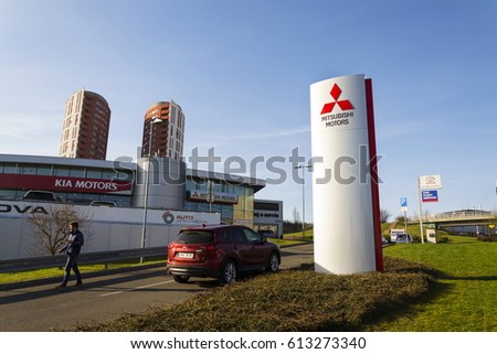 PRAGUE, CZECH REPUBLIC - MARCH 31: Mitsubishi motors company logo with Mazda car in front of dealership building on March 31, 2017 in Prague, Czech republic.