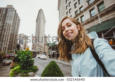 https://thumb1.shutterstock.com/display_pic_with_logo/936964/502146640/stock-photo-happy-young-woman-takes-selfie-self-portrait-near-flat-iron-building-in-manhattan-new-york-funny-502146640.jpg