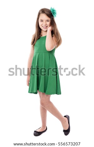 Full length portrait of a smiling pretty little girl isolated over white background