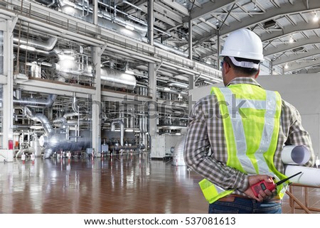 Engineer looking a boiler equipments and machinery in a modern thermal power plant industry