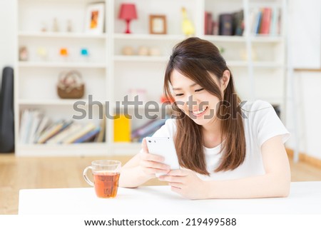 young attractive asian woman to see a smart phone