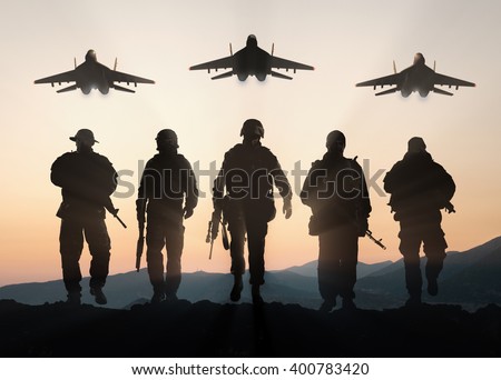 Military silhouettes of soldiers and airforce against the backdrop of sunset sky.