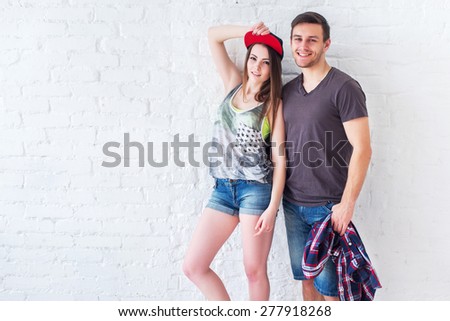 Young friends funny guys active people have fun together woman and man, girl and guy summer urban casual style.