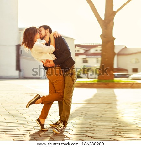 https://thumb1.shutterstock.com/display_pic_with_logo/952708/166230200/stock-photo-pretty-summer-sunny-outdoor-portrait-of-young-stylish-couple-while-kissing-on-the-street-166230200.jpg