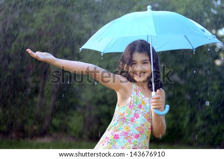 young girl enjoying the rain