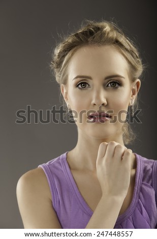 Color Portrait Of Beautiful Young Blonde Lady Wearing Soft Purple Shirt And Plum Lipstick As