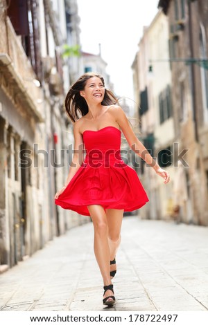 https://thumb1.shutterstock.com/display_pic_with_logo/97565/178722497/stock-photo-happy-beautiful-woman-in-red-summer-dress-walking-and-running-joyful-and-cheerful-smiling-in-venice-178722497.jpg