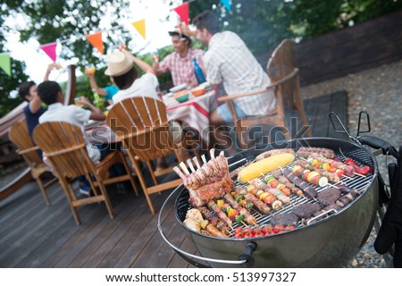 Family having a barbecue party in their garden in summer