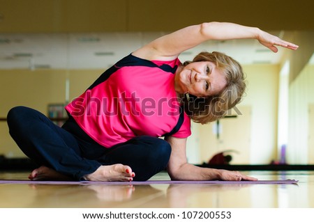 Mature Woman Does Yoga Side Bend