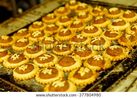 traditional freshly baked pineapple tarts on caramalized tray on display at the heritage city of malacca, normally ate during chinese lunar new year or other festivities and celebration