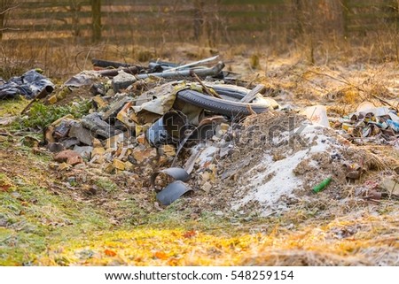 Unlegal dump near forest. Devastation of nature with rubbish