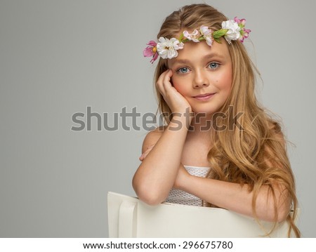 Fashion portrait of beautiful little girl with wreath