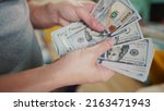 Small photo of dollar money. bankrupt man counting money cash. business crisis finance dollar concept. close-up of a hand counting paper dollars. exchange finance economy dollar usd pay tax