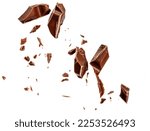  Levitating milk chocolate chunks isolated on white background. Flying Chocolate pieces, shavings and cocoa crumbs Top view. Flat lay