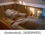 Small photo of Memphis, Egypt - December 21, 2022 - Scene of The colossus of Rameses II statue in Mit Rahina museum, open-air museum in Memphis