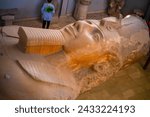 Small photo of Memphis, Egypt - December 21, 2022 - Scene of The colossus of Rameses II statue in Mit Rahina museum, open-air museum in Memphis