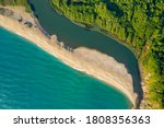 Beautiful sandy beach surrounded by sea waves on one side and on the other by the waters of a river that flows into the sea, the mouth of Veleka River at the Black sea coast, Bulgaria