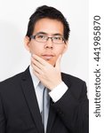 Small photo of Uhm i think about this business, Portrait of business asian smart man on white background